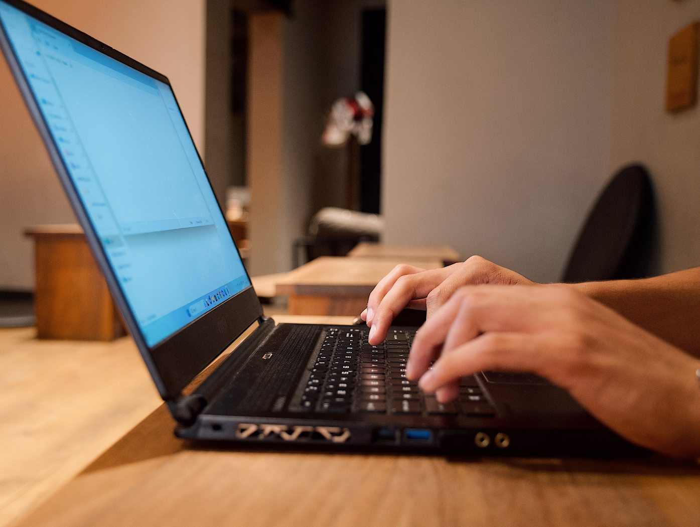 Hands working on a laptop